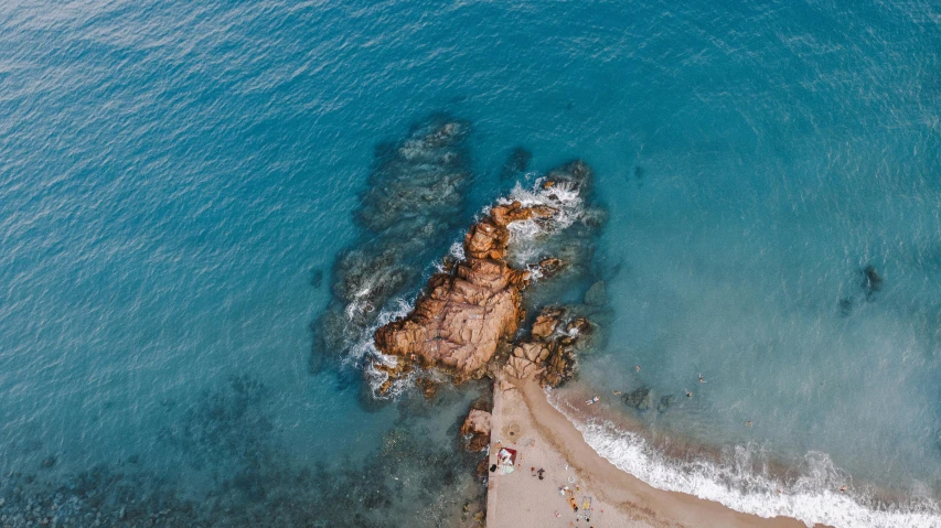 a large body of water next to a sandy beach, by Niko Henrichon, pexels contest winner, airborne view, costa blanca, flying rocky island, thumbnail