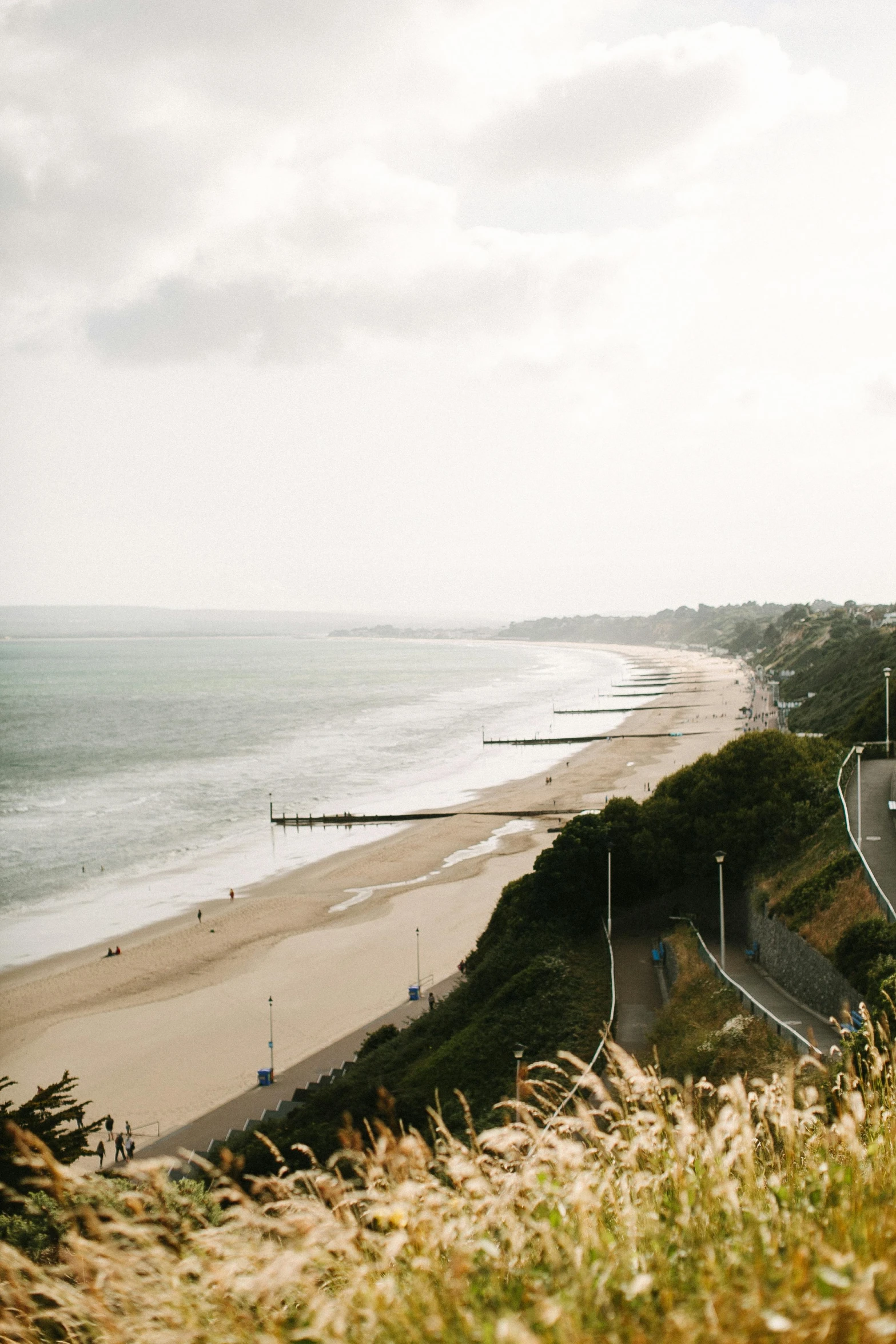 a view of a beach from the top of a hill, inspired by Richmond Barthé, unsplash, walking to the right, day light, d-day, wide