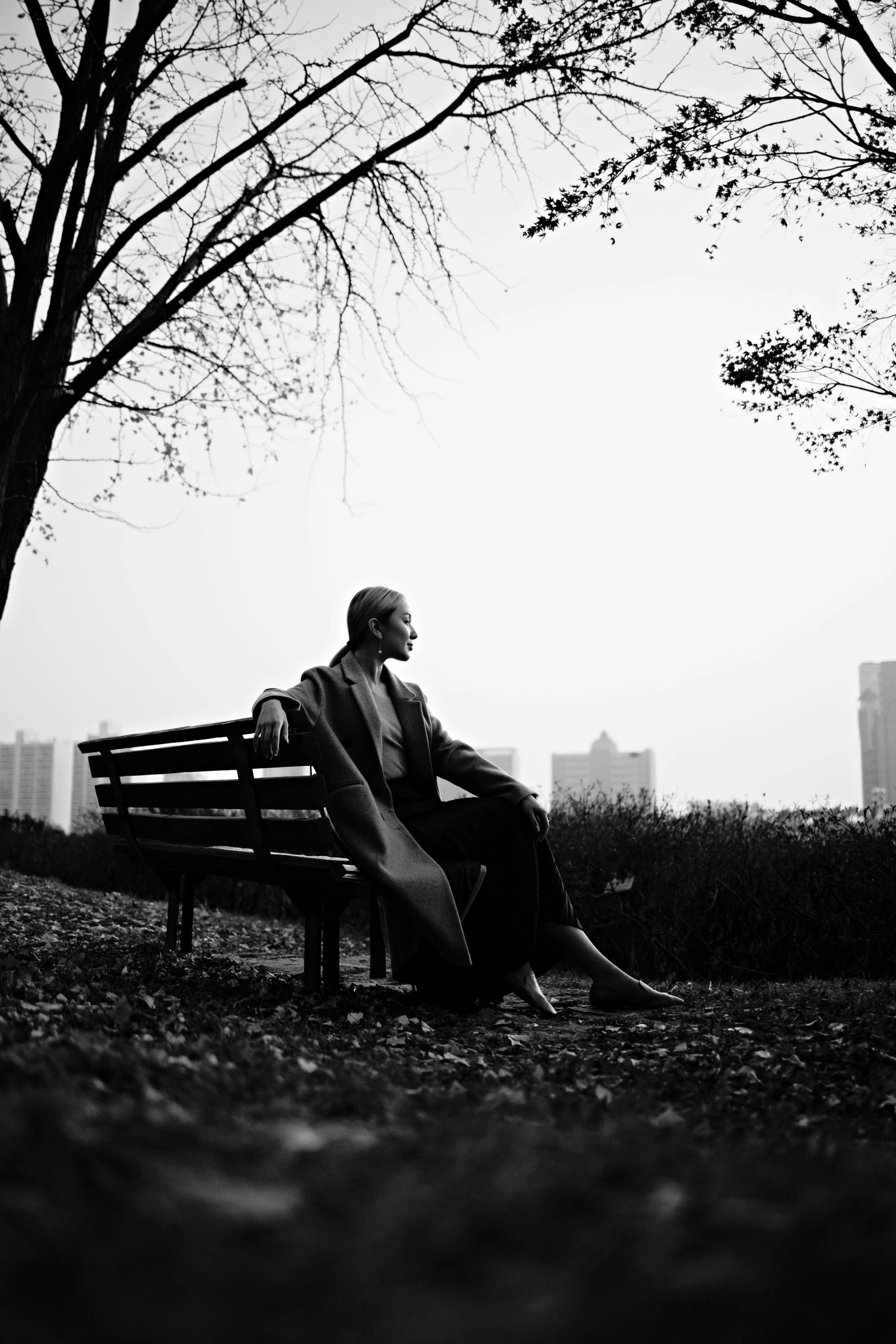 a black and white photo of a man sitting on a bench, a black and white photo, unsplash, conceptual art, ffffound, song nan li, in fall, gustavo fring