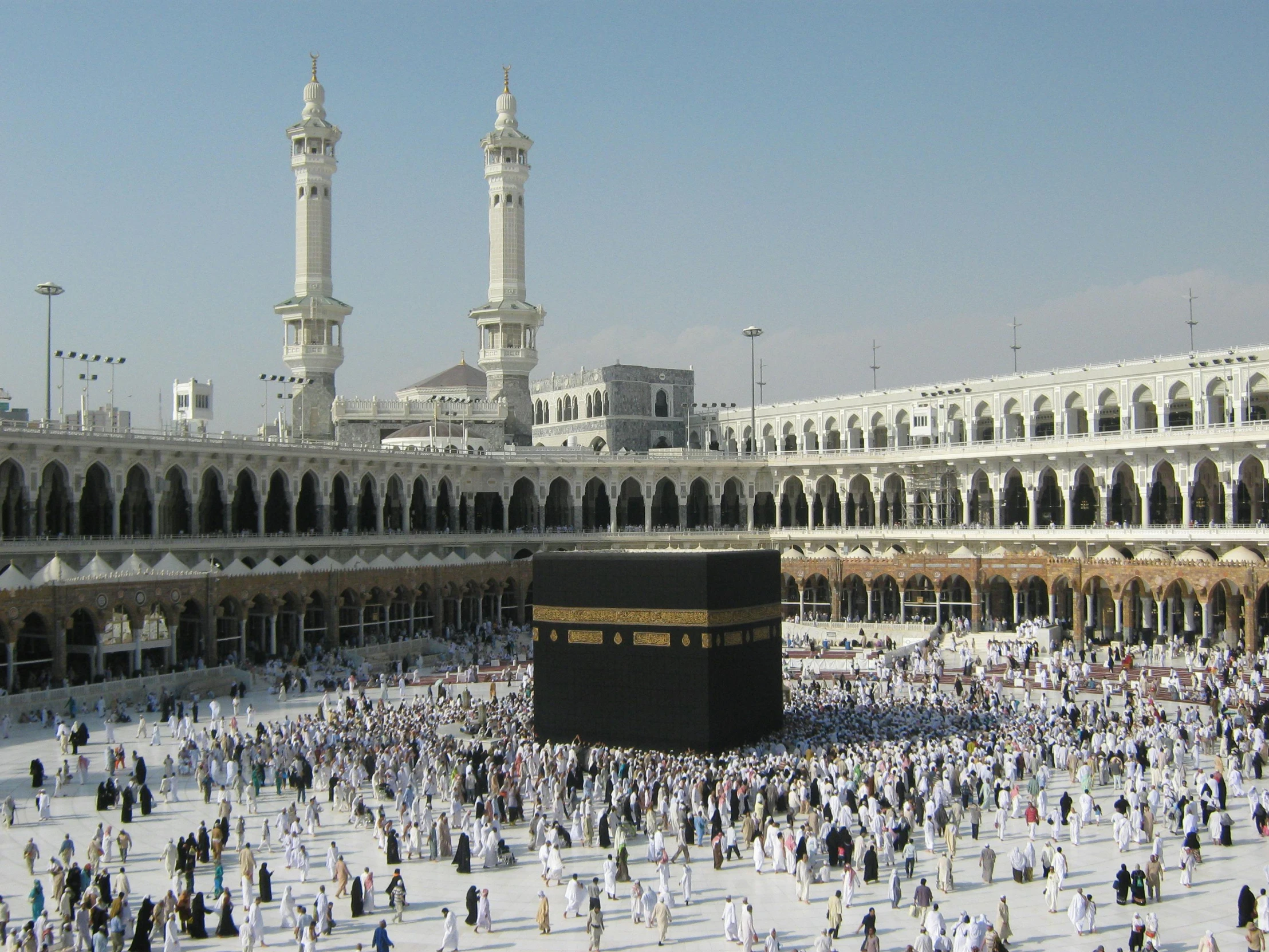 a large group of people standing around a building, by Sheikh Hamdullah, pexels contest winner, hurufiyya, square, white, amber, black