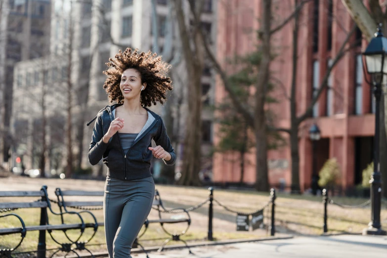a woman running in the park on a sunny day, happening, with a curly perm, humans of new york style, thumbnail, full res