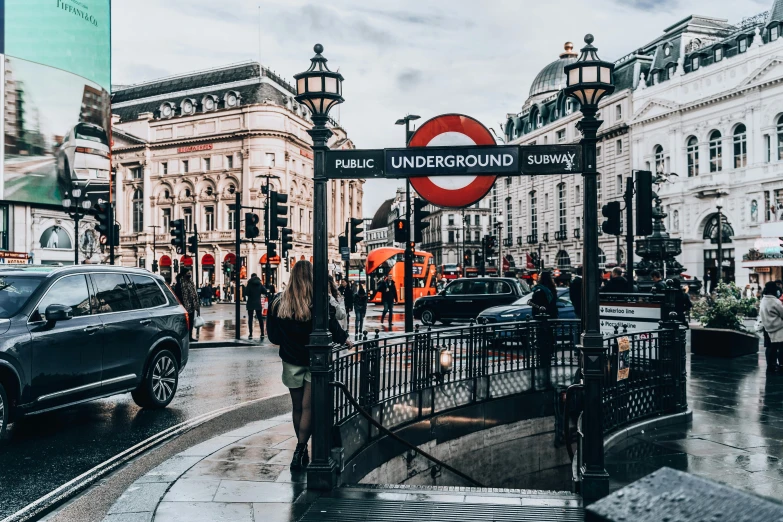 a city street filled with lots of traffic next to tall buildings, by Emma Andijewska, pexels contest winner, art nouveau, london underground tube station, on a great neoclassical square, thumbnail, square