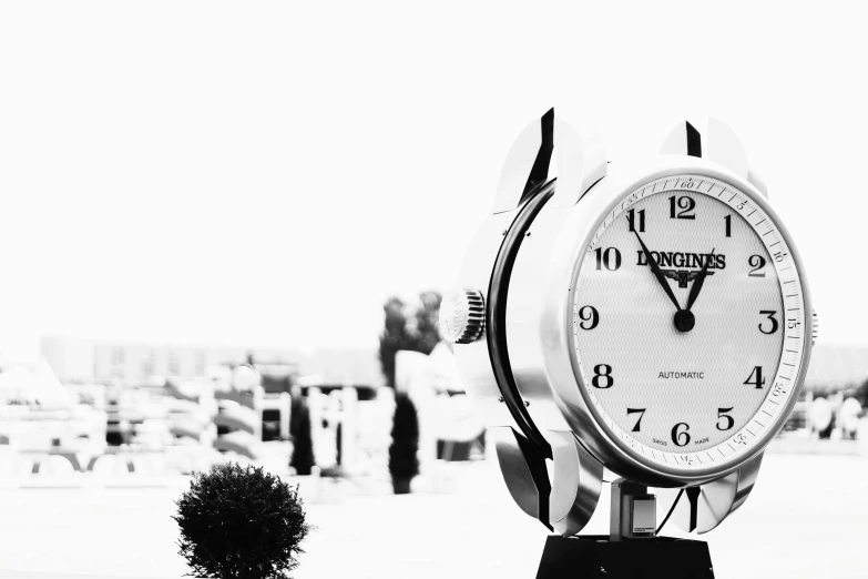 a black and white photo of a clock with people in the background, unsplash, breitling, beautiful views, lomography lady grey, 2 0 5 6 x 2 0 5 6