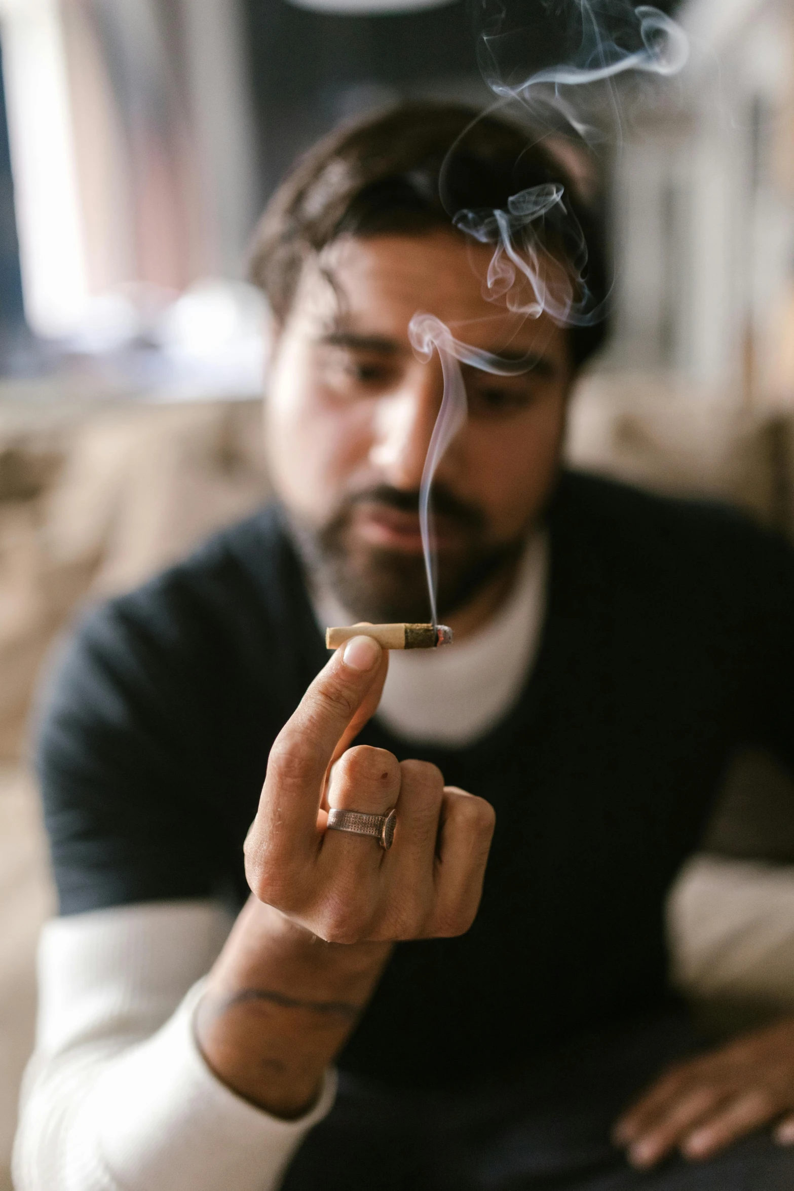 a man sitting on a couch smoking a cigarette, by Jessie Algie, pexels contest winner, renaissance, smoking a bowl of hash together, haze over the shoulder shot, ray william johnson, holding gold