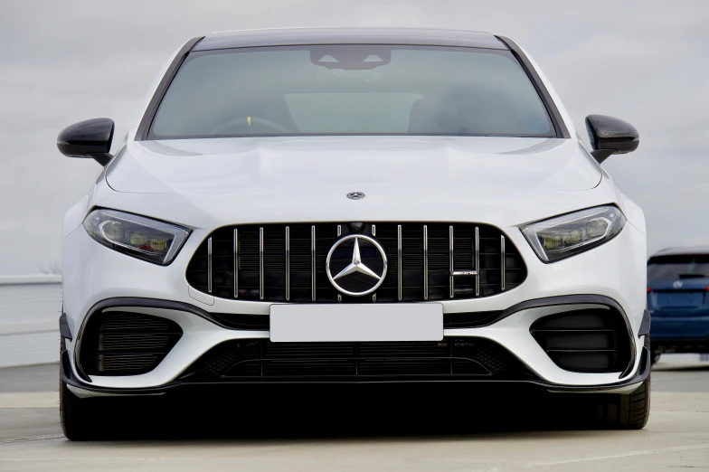 a white mercedes parked next to a body of water, square, frontal picture, thumbnail, car design