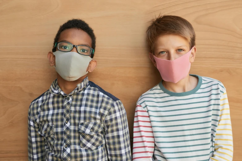 two young boys standing next to each other wearing face masks, by Alice Mason, official product photo, boys and girls, medium angle, with grey skin