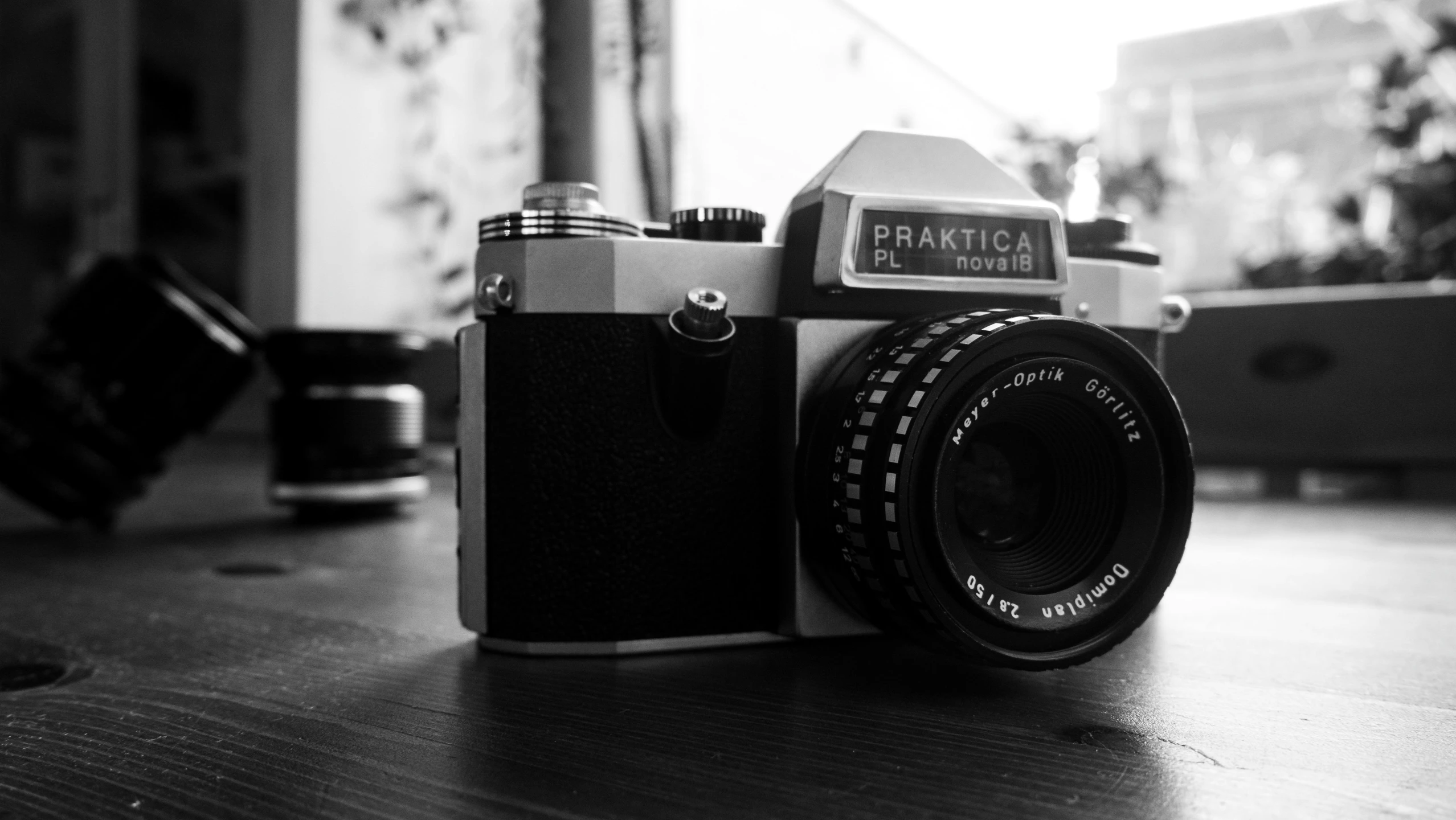 a black and white photo of a camera, by Adam Pijnacker, pexels contest winner, photorealism, photo taken with provia 1967, medium format. soft light, colorful pentax camera, practice