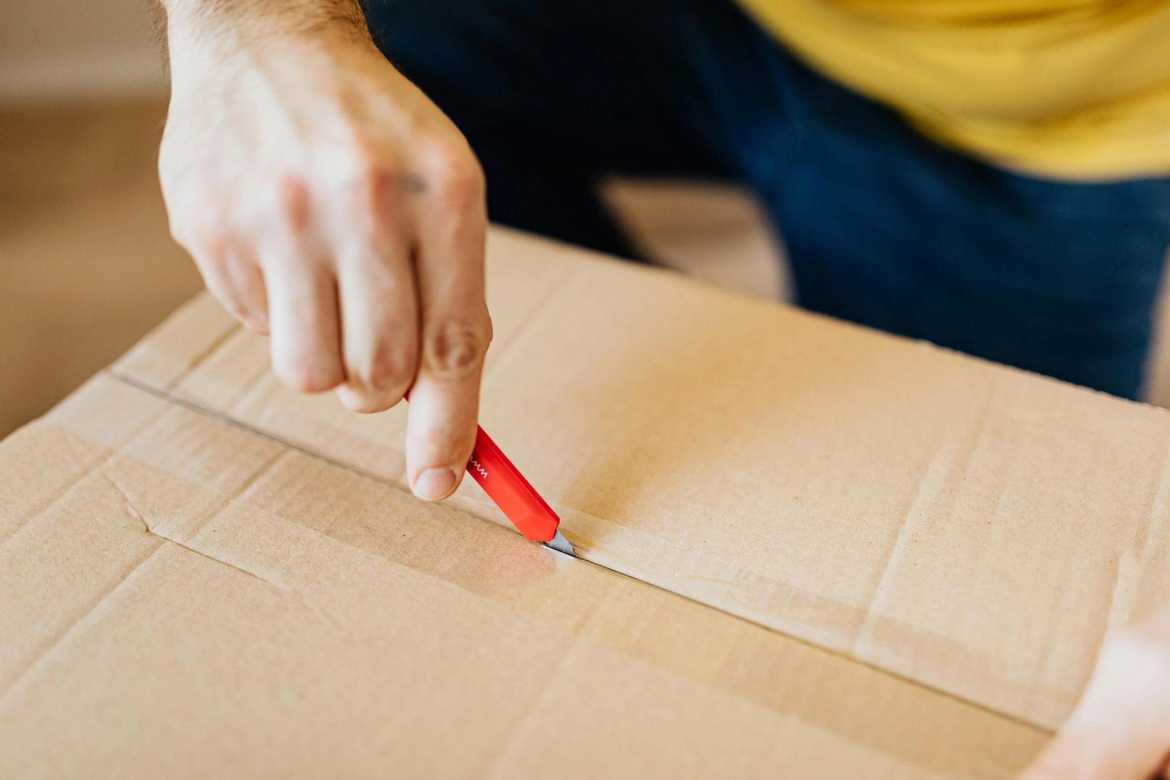 a person cutting a piece of cardboard with a pair of scissors, by Tom Bonson, pexels contest winner, hurufiyya, delivering parsel box, thumbnail, wētā fx, thick lining