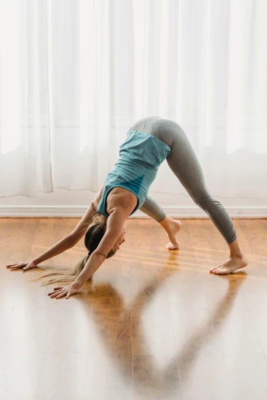 a woman doing a handstand on a hard wood floor, by Carey Morris, back shark fin, yoga pose, walking down, profile image