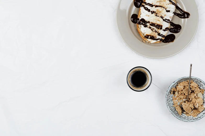 a plate of food next to a cup of coffee, trending on unsplash, minimalism, maple syrup & hot fudge, background image, cake, black