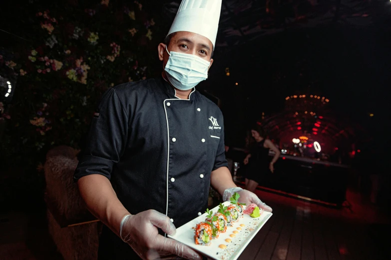 a man wearing a face mask holding a plate of food, chef platypus, sushi, multiple stories, vaughan ling