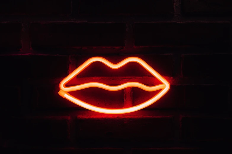 a neon lips sign on a brick wall, inspired by Elsa Bleda, trending on pexels, glowing red veins, light stubble, profile image, neon standup bar