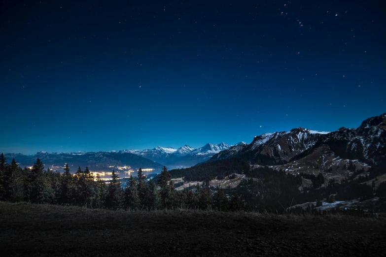 a view of the mountains at night from the top of a hill, by Sebastian Spreng, pexels contest winner, whistler, extra high resolution, deep blue night sky, slightly pixelated