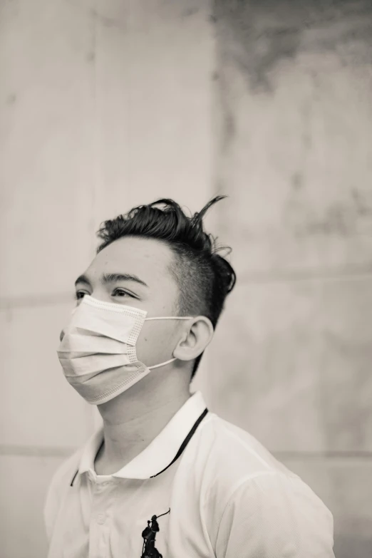 a black and white photo of a man wearing a face mask, inspired by Fei Danxu, pexels contest winner, shaved sides, young cute wan asian face, healthcare worker, taken in the late 2010s