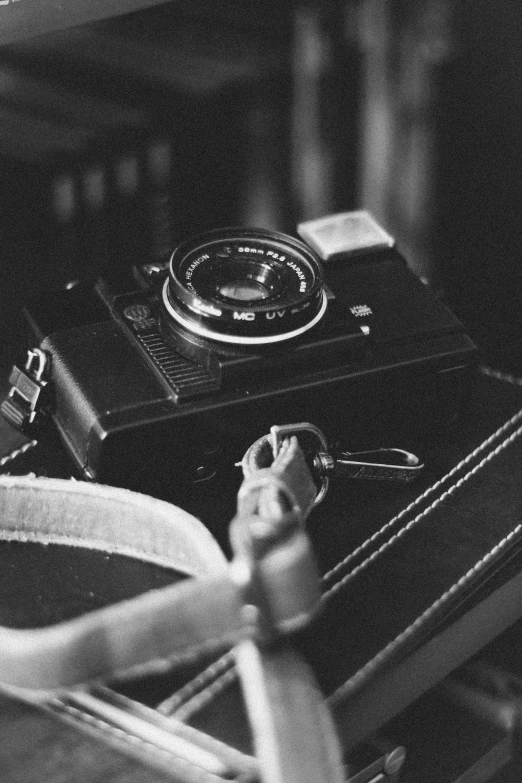 a black and white photo of an old camera, a black and white photo, by Adam Marczyński, unsplash, vintage soft grainy, canon a1, medium format, cute photograph