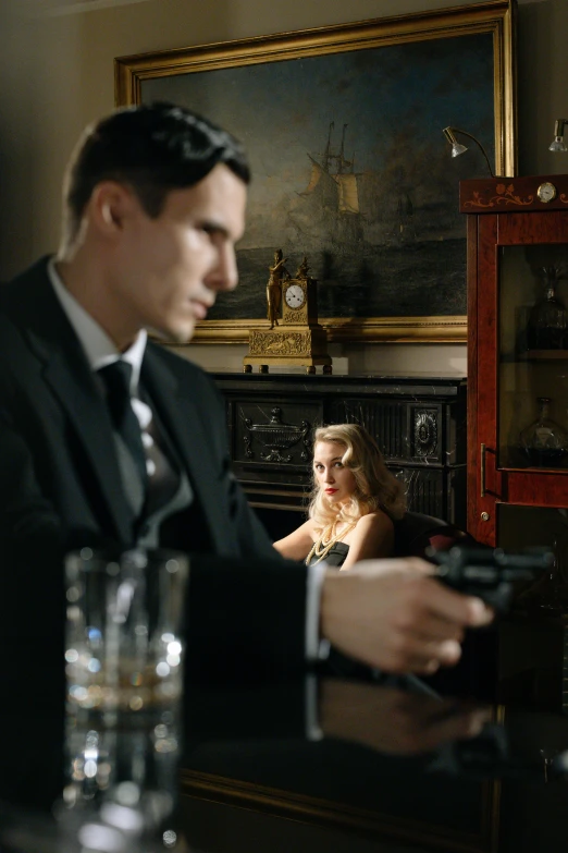 a man in a suit holding a gun, two models in the frame, iconic scene, speakeasy, history drama