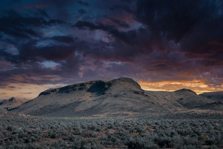 a mountain with a cloudy sky in the background, by Jeffrey Smith, unsplash contest winner, australian tonalism, black mesa, sunset panorama, sage, eerie color