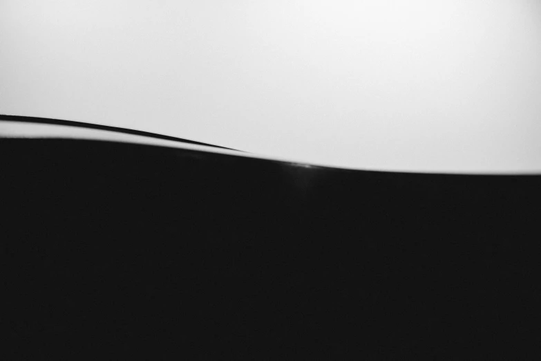 a computer mouse sitting on top of a desk, a black and white photo, inspired by Edward Weston, unsplash, minimalism, martian landscape, tall backlit waves, abstract album cover, dessert