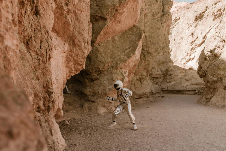 a man that is standing in the dirt, a digital rendering, pexels contest winner, modern space suit, natural cave wall, mars vacation photo, youtube thumbnail