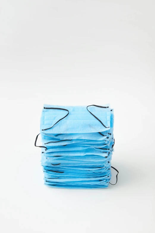 a stack of blue surgical masks on a white background, by Nicolette Macnamara, 256x256, frontal shot, usa, f / 2 0