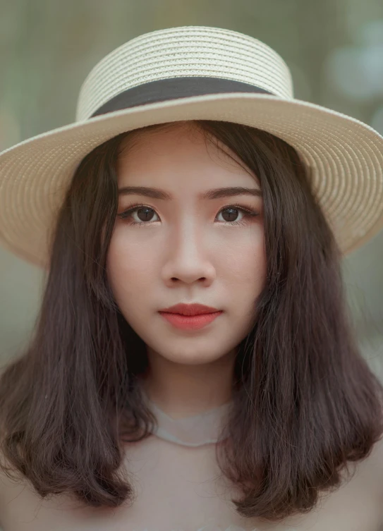 a close up of a person wearing a hat, inspired by Tan Ting-pho, pexels contest winner, photorealism, young cute wan asian face, slender symmetrical face, light makeup, tourist photo