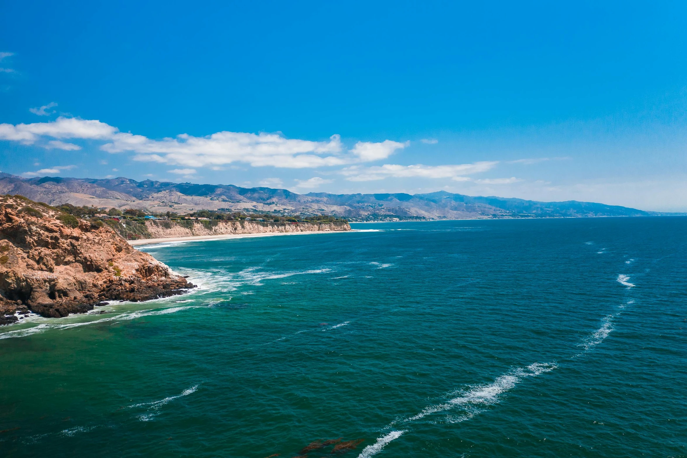 a large body of water next to a beach, pexels contest winner, malibu canyon, blue clear skies, zenith view, profile image