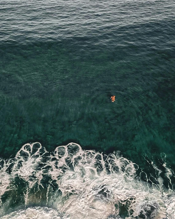 a person riding a surfboard on top of a body of water, pexels contest winner, minimalism, smiling down from above, ocean sprites, bali, slide show
