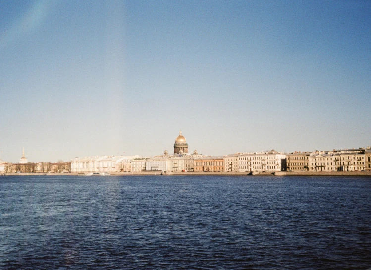 a large body of water with buildings in the background, pexels contest winner, neoclassicism, sunfaded, russian academic, fujifilm superia, slightly sunny