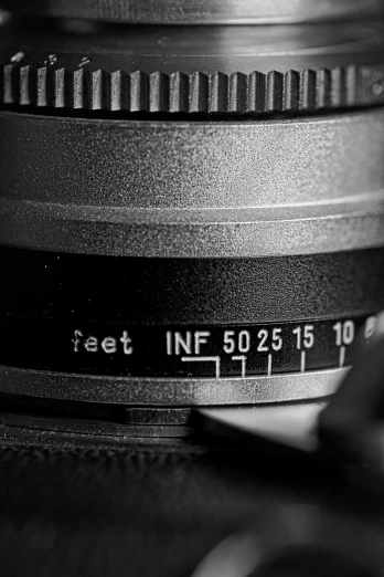 a black and white photo of a camera lens, a macro photograph, unsplash, 5 feet distance from the camera, iso 500, arriflex lens, macro up view metallic