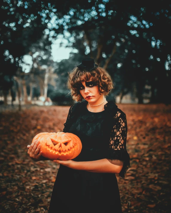 a woman in a black dress holding a pumpkin, pexels contest winner, lowbrow, androgynous person, sophia lillis, ☁🌪🌙👩🏾, fancy dress