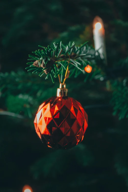 a red ornament hanging from a christmas tree, inspired by Ernest William Christmas, pexels, avatar image, warm coloured, emerald, thumbnail