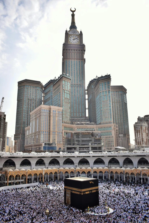 a crowd of people surrounding a building with a clock tower in the background, by Sheikh Hamdullah, gigantic skyscrapers, palace floating in the sky, mega structure, high - angle