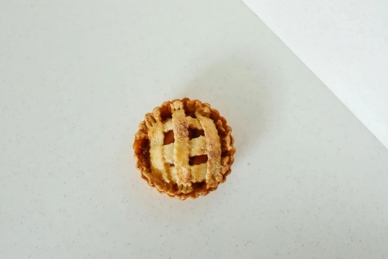 a close up of a pie on a table, mini, product image, 3/4 front view, individual