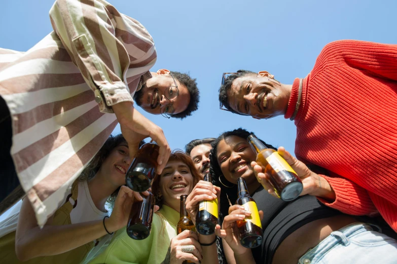 a group of people standing around each other holding beer bottles, pexels contest winner, renaissance, blue sky, hispanic, slide show, bottom angle