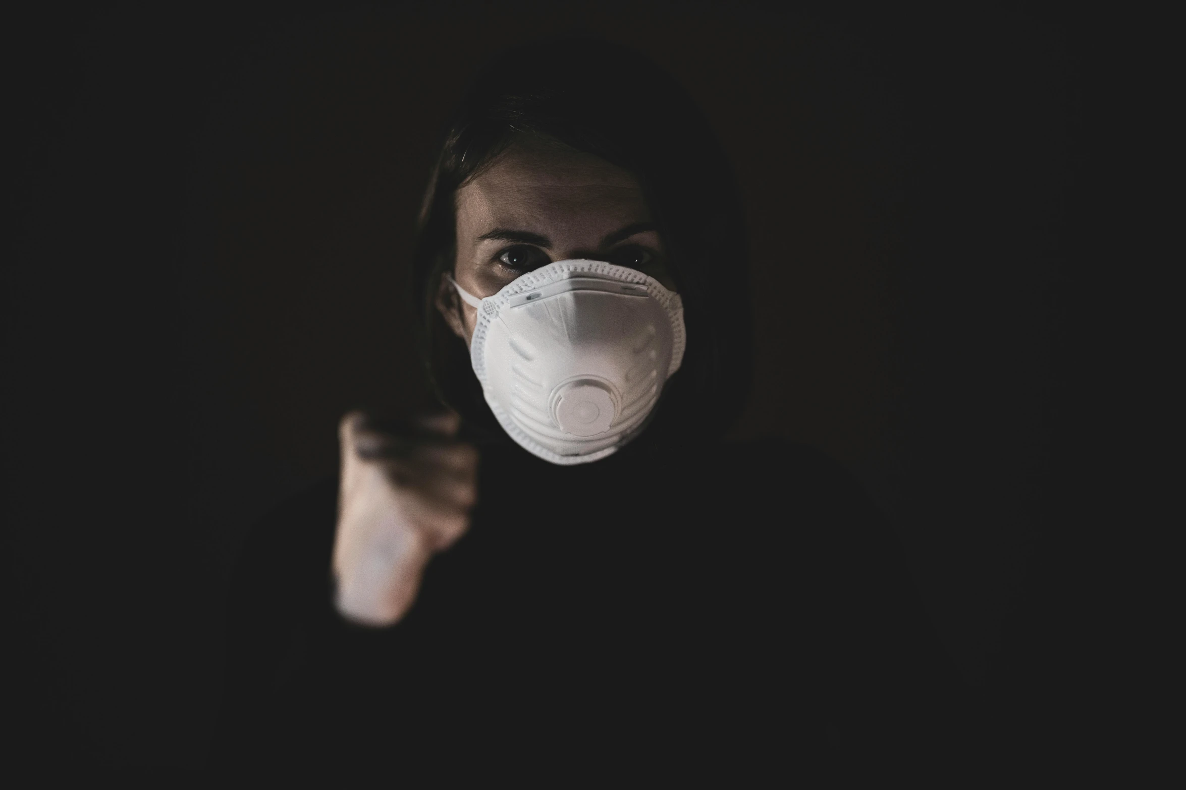 a woman wearing a face mask in the dark, pexels contest winner, threatening pose, dust mask, plain background, avatar image