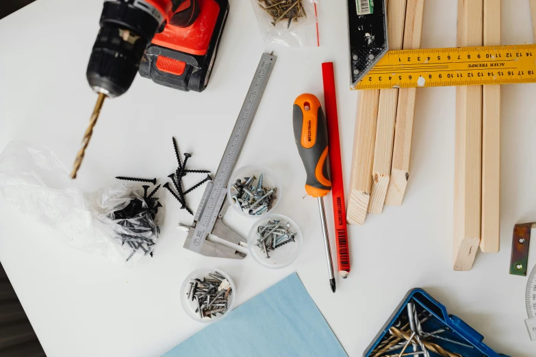 a table topped with tools on top of a white table, pexels contest winner, 15081959 21121991 01012000 4k, screws, product introduction photo, abcdefghijklmnopqrstuvwxyz