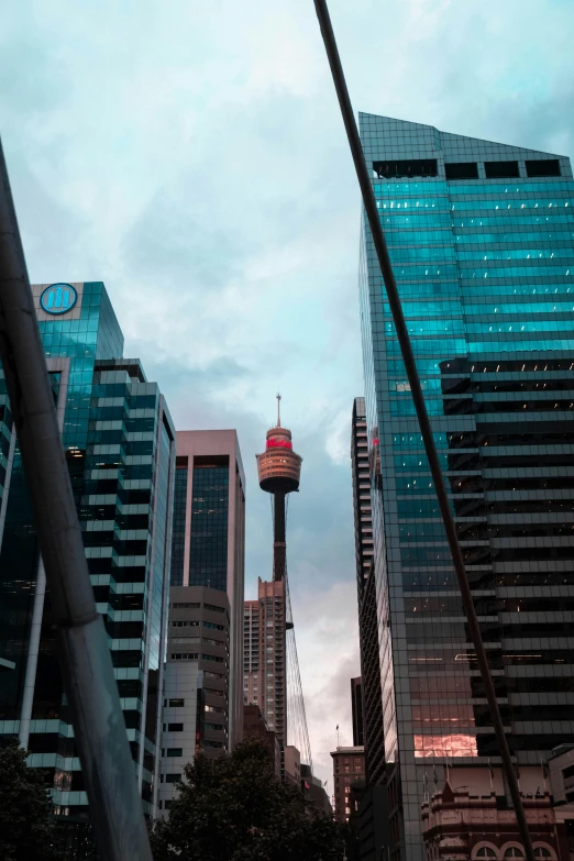 a city street filled with lots of tall buildings, a picture, inspired by Sydney Carline, pexels contest winner, hurufiyya, 🤠 using a 🖥, towers, view from bottom, neon city domes