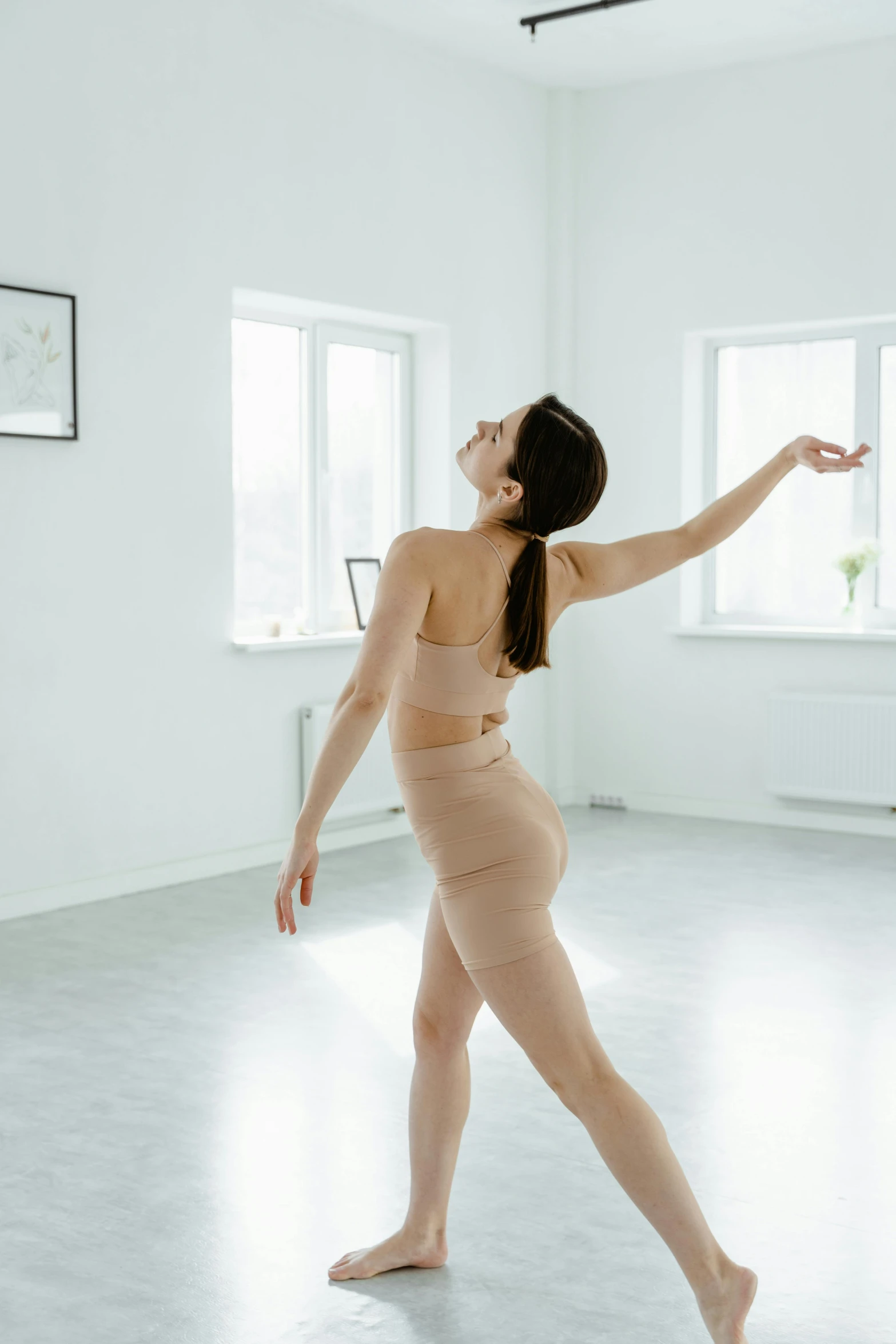a woman that is standing in a room, by Elizabeth Polunin, arabesque, waist reaching ponytail, in a white room, best practice, silicone skin