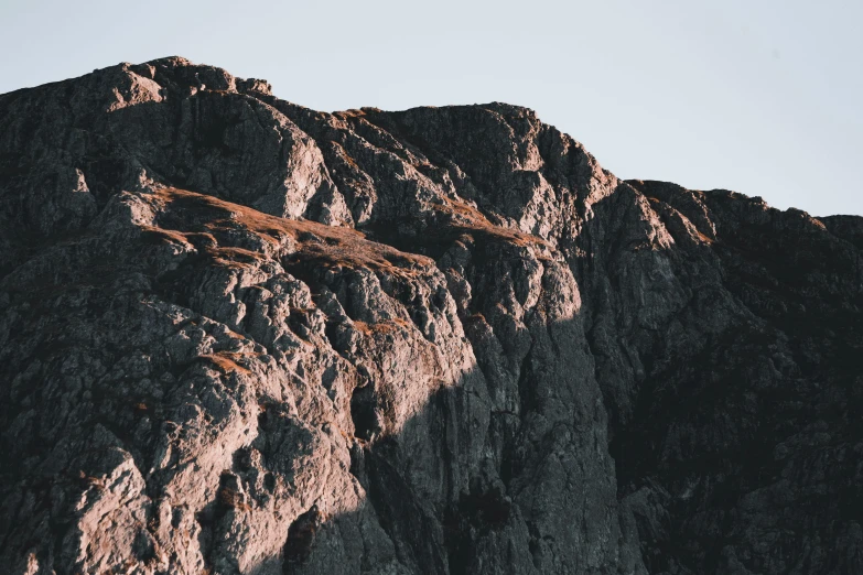 a group of people standing on top of a mountain, unsplash contest winner, minimalism, extremely detailed rocky crag, dappled in evening light, seen from a distance, grey