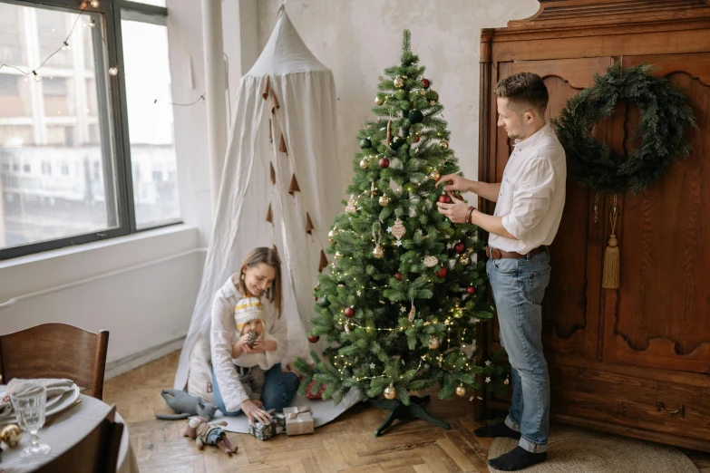 a man and a woman decorating a christmas tree, pexels contest winner, kids, pokimane, fan favorite, 000 — википедия