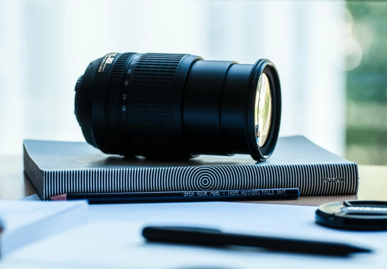 a camera lens sitting on top of a book, pexels contest winner, ultrawide lense, sigma lens, headshot, hd footage