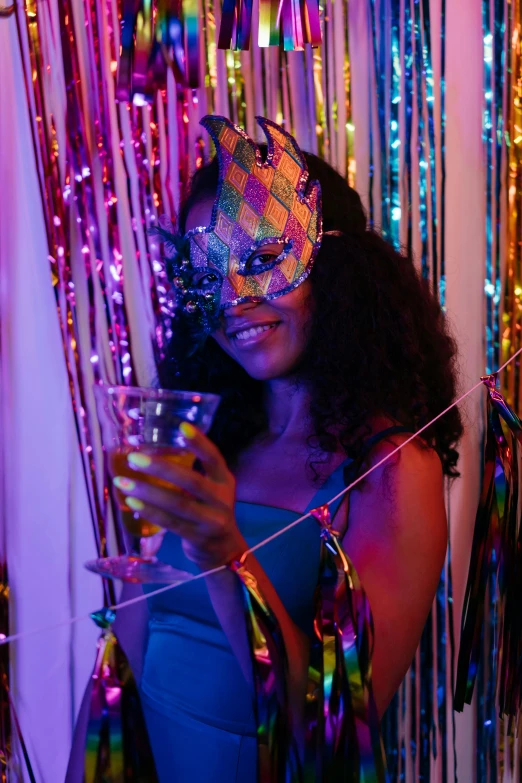 a woman in a party mask holding a glass, a photo, trending on pexels, renaissance, iridescent visor, dark-skinned, party balloons, bisexual lighting