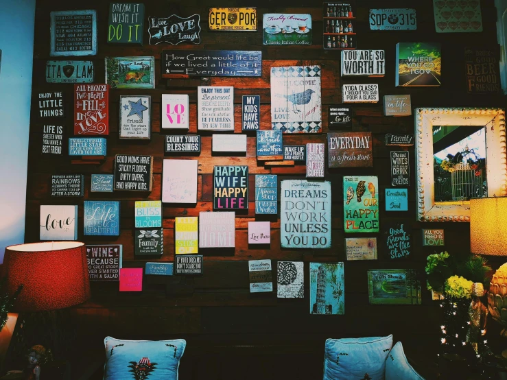 a living room filled with lots of posters on the wall, by Julia Pishtar, trending on unsplash, in a coffee shop, teal paper, all things cease to exist, rustic