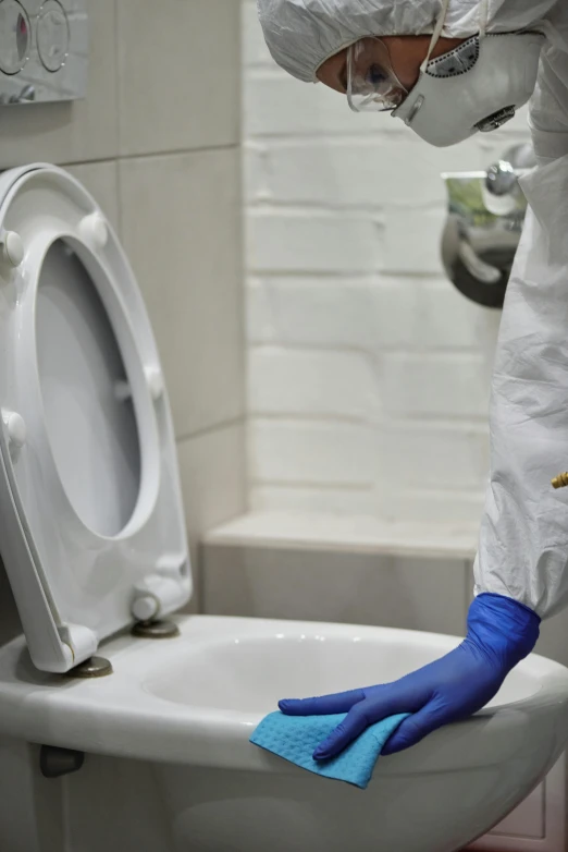 a person in protective gear cleaning a toilet, by Julia Pishtar, exclusive, sao paulo, 8l, sink