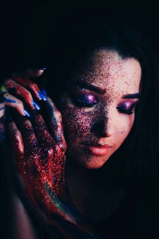 a woman with glitter on her face and hands, an album cover, inspired by Elsa Bleda, trending on pexels, red and purple coloring, spraypaint, professional body paint, ariana grande photography