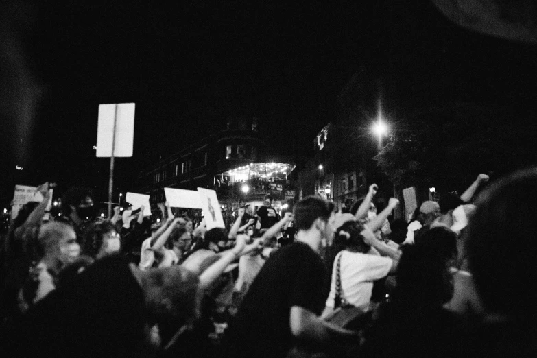 a black and white photo of a crowd of people, sots art, the torch we all must hold, summer night, raised fist, washington dc