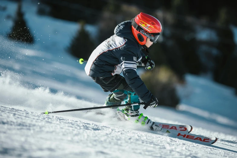 a man riding skis down a snow covered slope, pexels contest winner, sport clothing, avatar image, boys, helmet