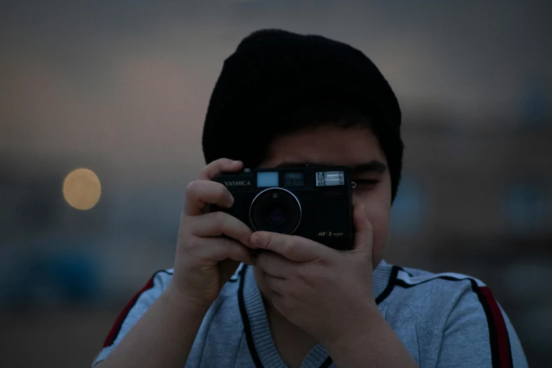 a person taking a picture with a camera, by Ahmed Yacoubi, teenage boy, avatar image, ((sharp focus)), little kid
