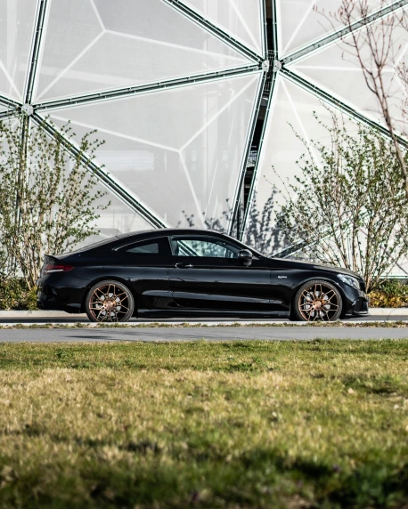 a black car parked in front of a building, profile image, mercedes, black wheel rims, brown