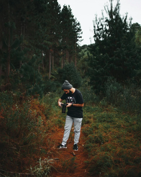 a man standing in the middle of a forest, a polaroid photo, unsplash contest winner, graffiti, inspect in inventory image, cute photo, ((forest)), streetwear